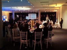 a group of people sitting at tables in a room