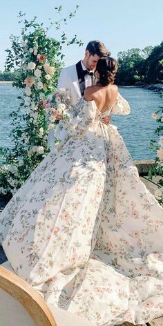 a bride and groom are kissing on a boat in front of the water at their wedding