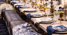 a long table set with plates and silverware