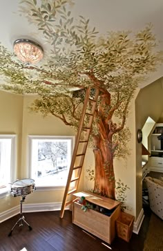 a room with a tree painted on the ceiling and ladder up to it's roof