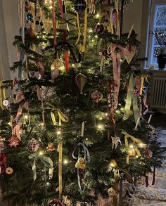 a decorated christmas tree with ribbons on it