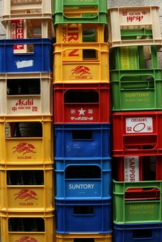 many different colored bins stacked on top of each other