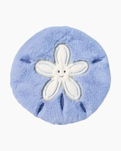 a blue and white flower shaped pillow on a white background with the word's name written