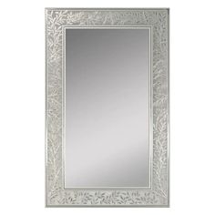 an ornate silver framed mirror on a white wall with leaves in the middle and bottom