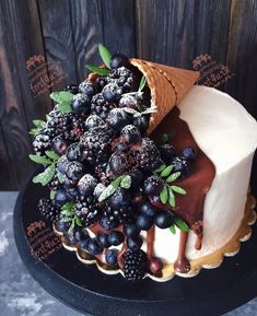 there is a cake with berries and ice cream on it