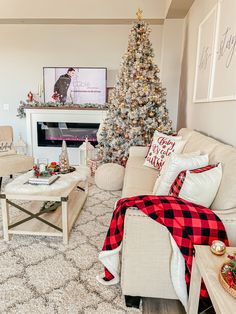 a living room filled with furniture and a christmas tree