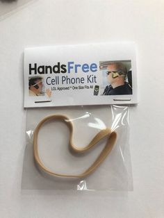 the cell phone kit is packaged in plastic and has a rubber hook attached to it