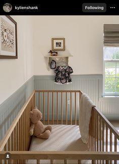 a baby crib with a teddy bear in it