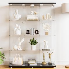 a shelf filled with white vases and other items on top of a wooden table