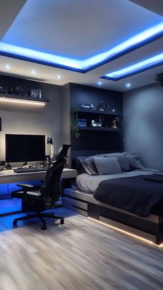 a bedroom with a bed, desk and tv in the corner is lit up by blue lights