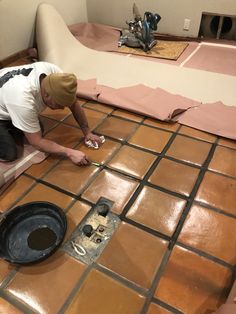 a man is working on the floor in his home