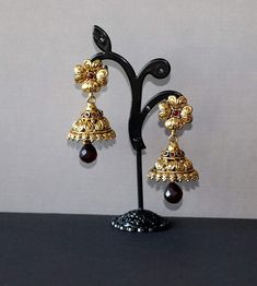 These gorgeous Antique floral gold plated Jhumka Dangly Earrings are set in red onyx stones. Earring length 2.5 inches. Earring width: 1 inches. Temple Jewelry Kundan Jhumkas For Pierced Ears, Festive Brass Jhumkas, Ceremonial Jhumkas With Latkans, Gold Plated Latkans Temple Earrings, Gold Plated Latkans Temple Jewelry Earrings, Gold Plated Temple Jewelry Earrings With Latkans, Temple Jewelry Jhumkas As A Gift, Gift Temple Jewelry Jhumkas, Festive Ceremonial Jhumkas Drop Earrings