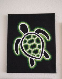 a painting of a turtle on a black and green square with white outline in the center