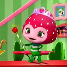 a cartoon character holding a candy cane in front of a green striped room with pictures on the wall