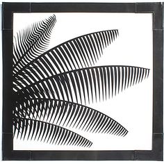 a black and white photo of palm leaves on a white background, framed in wood frame