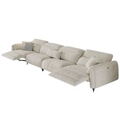 a white couch with two recliners and pillows on top of it's back