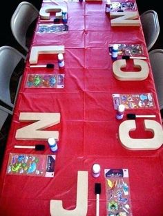 the table is covered with red cloth and letters that spell out jnj on it