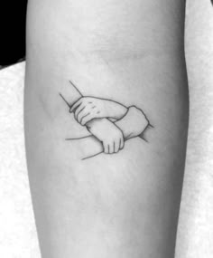 a black and white photo of a wrist tattoo