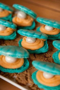 there are some cookies with blue icing and white frosting in the shape of spaceships