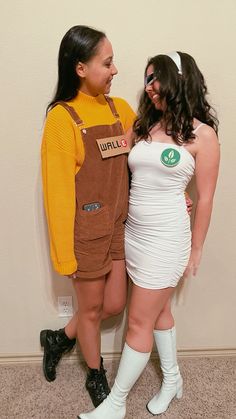 two women dressed in costumes standing next to each other