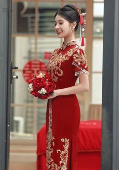 a woman in a red dress holding flowers