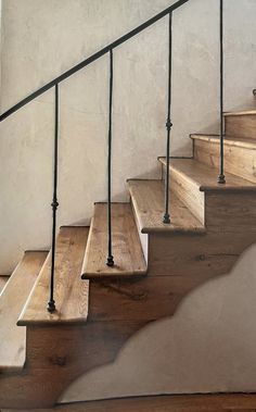 a set of wooden stairs with metal handrails