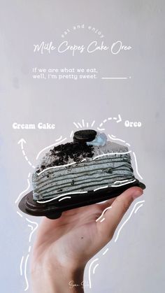 a hand holding a piece of cake with frosting and oreo on it's side