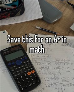 a calculator sitting on top of a table next to some paper and pen