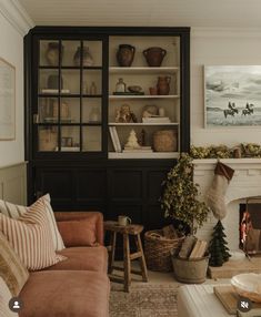 a living room filled with furniture and a fire place next to a mantle covered in christmas stockings