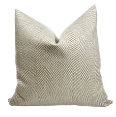 a white pillow with an arrow pattern on the front and back, sitting on a white background