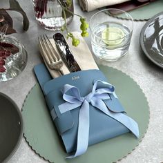 a place setting with blue napkins and silverware