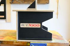 a small black box with the word rtt on it sitting on top of a wooden table