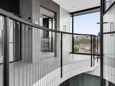 the interior of a modern home with stainless steel railings and glass doors on both sides