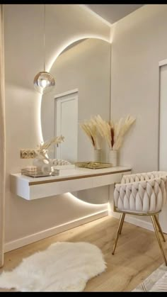 a white chair sitting in front of a mirror on top of a counter next to a table