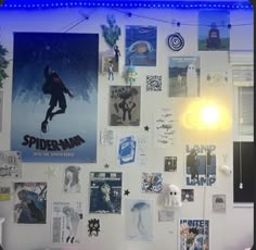 a white wall covered in posters and lights