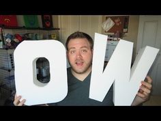 a man is holding up the letters that spell out word no in front of him