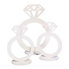 two white rings with diamond cutouts on them