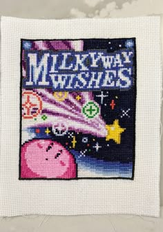 a cross stitch picture with the words happy new year written in blue and pink on it