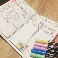 an open birthday planner with markers and pens