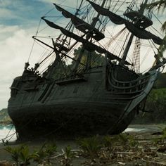 an old pirate ship sitting on the beach