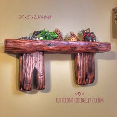 a wooden shelf with three small figurines on top of it and two other decorations