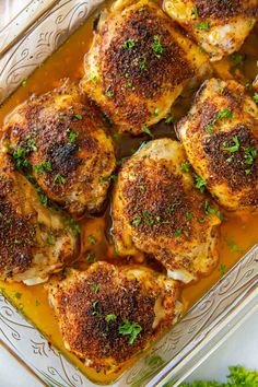 baked chicken thighs in a baking dish with parsley