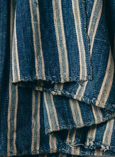 blue and white striped fabric folded up on top of each other in closeup view