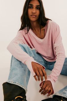 The *perfect* layering piece. This pullover from our We The Free collection features a hand-dyed technique where sprayed color is applied to the reverse side for a unique textured finish. **Fit:** Slouchy, relaxed fit **Features:** Soft cotton fabrication, wide V-neckline, dropped dolman sleeves with cuffed detail, ribbed trim, contrast seam detail throughout, vented sides **Why We ❤ It:** The hand-dyed nature of this pullover makes each piece unique and one-of-a-kind. | We The Free Gibson V-Nec Pink Washed Long Sleeve Top, Faded Long Sleeve Tops For Spring, Trendy Bleached Long Sleeve Tops, Trim Contrast, Layering Pieces, Dolman Sleeve, Active Wear For Women, Shoulder Sleeve, Boho Outfits