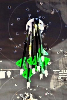 a group of green fighter jets are flying in the sky with stars and circles around them