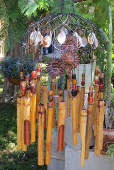 an outdoor wind chime with shells hanging from it