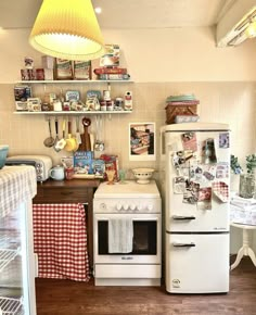 a white stove top oven sitting inside of a kitchen next to a refrigerator freezer