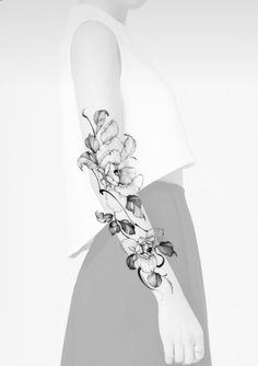 a woman's arm with flowers on it