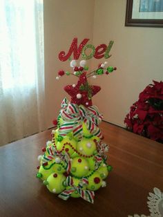 a decorated christmas tree sitting on top of a wooden table