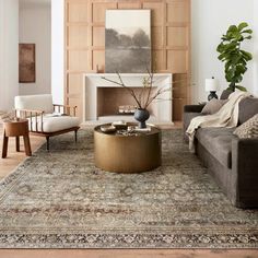 a living room filled with furniture and a fire place in the middle of a room